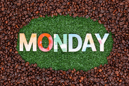 Close up of monday word made from colorful letters on artificial grass surrounded by roasted coffee beansの写真素材