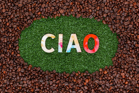Close up of Ciao word made from colorful letters on artificial grass surrounded by roasted coffee beansの写真素材