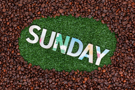 Close up of sunday word made from colorful letters on artificial grass surrounded by roasted coffee beansの写真素材