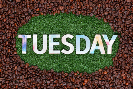 Close up of tuesday word made from colorful letters on artificial grass surrounded by roasted coffee beansの写真素材