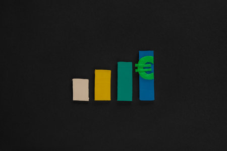 A graph made from colored columns made from plasticine on black background, shot from above.の写真素材