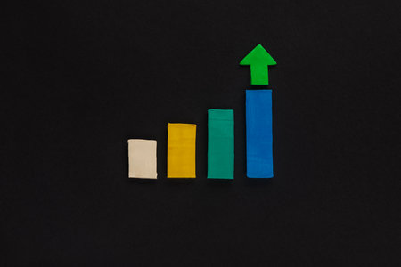 A graph made from colored columns made from plasticine on black background, shot from above.の写真素材
