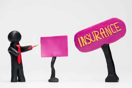 A man made from black plasticine making a presentation about insurance, on white background.の写真素材