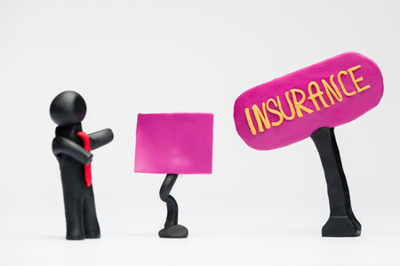 A man made from black plasticine making a presentation about insurance, on white background.の写真素材