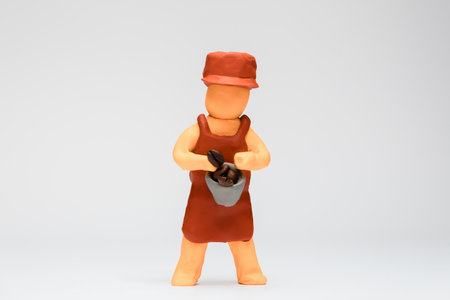 A barista made from plasticine on white background, aligned in the center.の写真素材