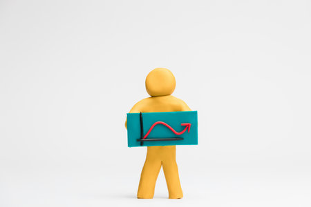 A man holding a graph with an red arrow falling and rising on white background, aligned in the center.の写真素材