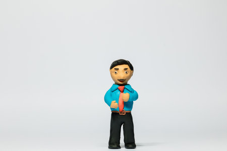 A businessman made from plasticine on white background, aligned in the center.の写真素材