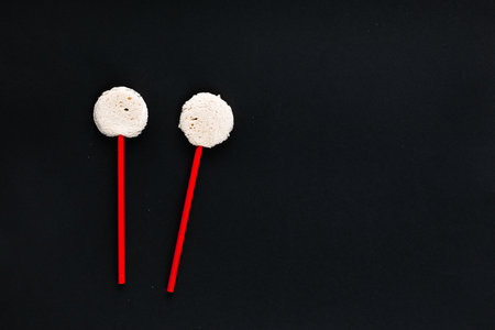 Two red sticks with circle shaped bread on top, shot top viewの写真素材