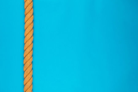 A gym battle rope on blue background, shot from above.の写真素材