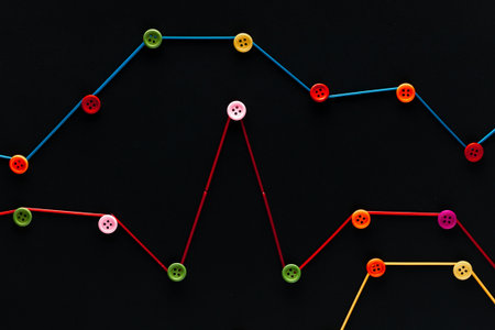 Three graphs of different colors on a black background , shot from above.の写真素材