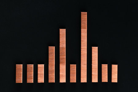 A graph made with colored staples on a black background , shot from above, closeup.の写真素材