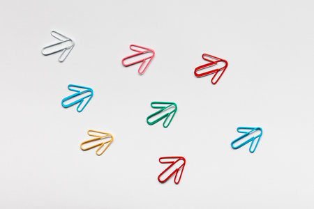 Many small colorful arrows pointing upwards on white background, shot from above, closeup.の写真素材