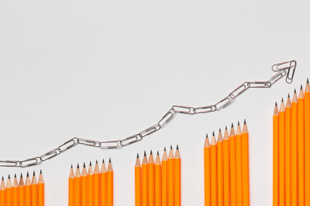 A bunch of pencils arranged in columns in an ascending order on white background, shot from above. closeup.の写真素材