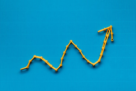 An orange graph on ocean blue background, shot from above.
