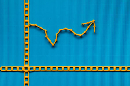 An orange graph on ocean blue background, shot from above.の写真素材