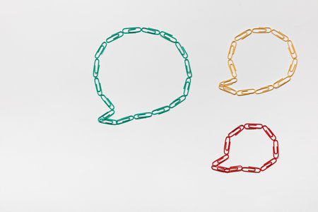 Communication bubble all made from paperclips of different colors on white background , shot from above.の写真素材