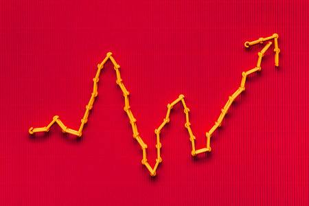 An orange graph on red background, shot from above.の写真素材