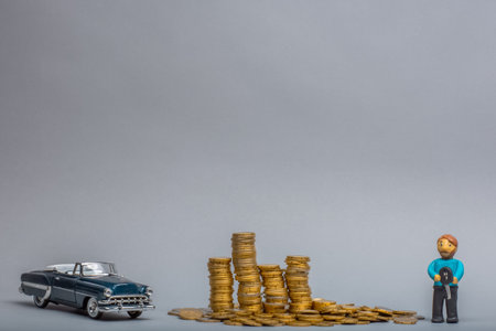 Big pile of golden coins in between a retro, blue car figurine and a plasticine man holding key, on...