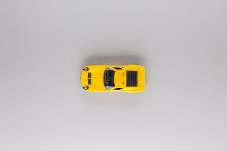 An yellow car figurine, shot from above, white background, aligned in the center.の写真素材