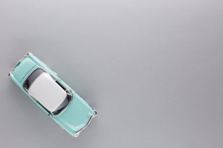 A light blue car figurine, shot from above, white background.の写真素材