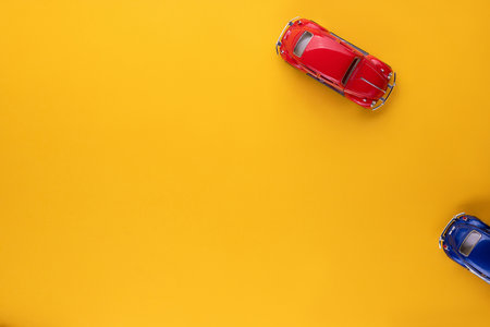 A red car figurine shot from above, on yellow background, aligned in the top right corner.の写真素材