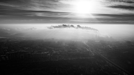 Beautiful black and white shot of a moldavian city underneath a clouded sky and a bright sun.の写真素材
