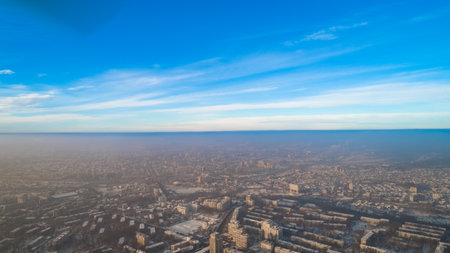Shot of a beautiful city and a small forest, during a cold, snowy winter.の写真素材
