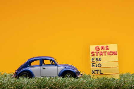Chisinau, Moldova - August 15th 2019: A blue car figurine aligned to the left on grass next to an...