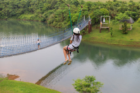 Apr 23, 2017 Woman sliding on a zip line adventure at Mountain lake resort in Laguna, Philippinesのeditorial素材