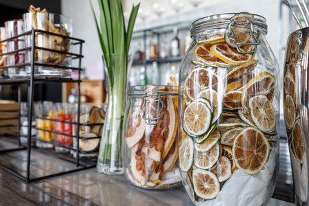 Dried grapefruit chips in the glass jar on the bar tableの写真素材