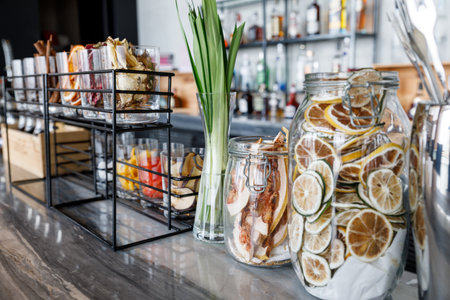 Dried grapefruit chips in the glass jar on the bar tableの写真素材