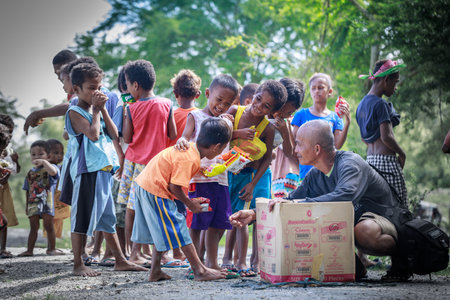 Filipino children standing in a line and holding snack in their hands on Aug 27 2017 in Santa Juliana, Capas, Central Luzon, Philippinesのeditorial素材