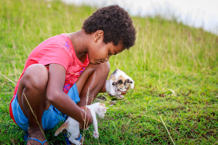 Portrait of Aeta tribe little girl with her cute cat near Mount Pinatubo on Aug 27, 2017 in Santa Juliana, Capas, Central Luzon, Philippinesのeditorial素材
