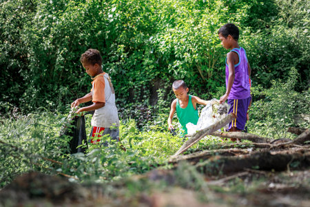 Filipino Children picking up trash(Environmental Protection Campaign) near Mount Pinatubo on Aug 27, 2017 in Santa Juliana, Capas, Central Luzon, Philippinesのeditorial素材