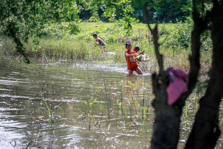 Filipino Children picking up trash(Environmental Protection Campaign) near Mount Pinatubo on Aug 27, 2017 in Santa Juliana, Capas, Central Luzon, Philippinesのeditorial素材