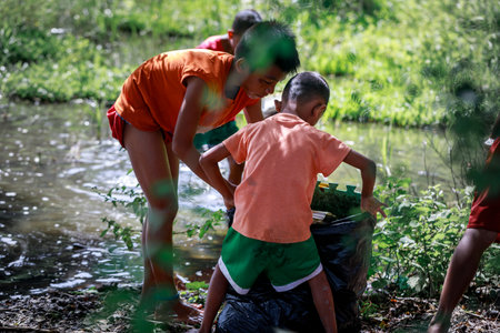 Filipino Children picking up trash(Environmental Protection Campaign) near Mount Pinatubo on Aug 27, 2017 in Santa Juliana, Capas, Central Luzon, Philippinesのeditorial素材