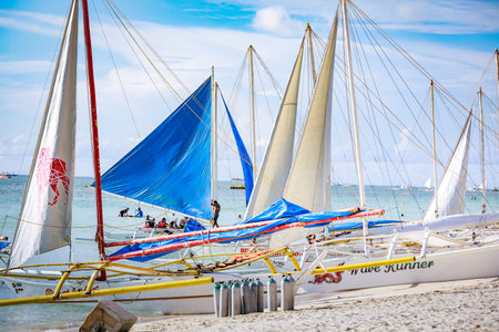 BORACAY ISLAND, PHILIPPINES - November 18, 2017 : Traditional Sailboats on Crowded Boracay white...