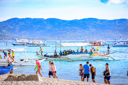 BORACAY ISLAND, PHILIPPINES - November 18, 2017 : Traditional Sailboats on Crowded Boracay white beachのeditorial素材