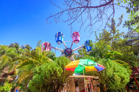 BORACAY ISLAND, PHILIPPINES - November 18, 2017 :  The Ferris wheel, which meets the blue sky, is circling among the trees at D-mall in Boracay Islandのeditorial素材