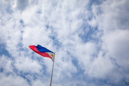 Philippine flag on a pole against blue sky