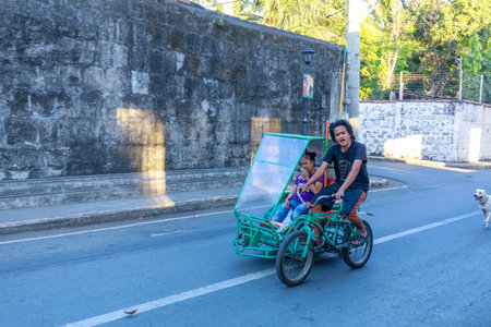 Manila, Philippines - Feb 17, 2018 : A man riding bicycle at Intramuros district, Manila cityのeditorial素材
