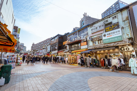Seoul, South Korea - March 2, 2018 : Local shops - lined at Hongdae (Hongik University) shopping street. Hongdae is a shopping cultural street for young people in Seoul.のeditorial素材