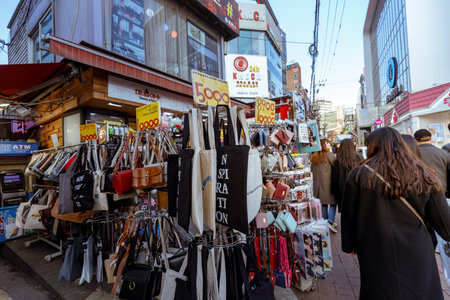 Seoul, South Korea - March 2, 2018 : Local shops - lined at Hongdae (Hongik University) shopping street. Hongdae is a shopping cultural street for young people in Seoul.のeditorial素材