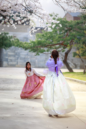 Seoul, South Korea - Apr 6, 2018 : Asian Korean woman dressed Hanbok in traditional dress walking in Gyeongbokgung Palaceのeditorial素材