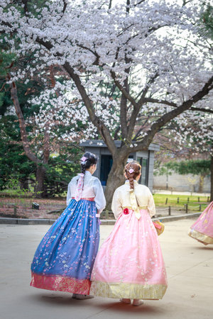 Seoul, South Korea - Apr 6, 2018 : Asian Korean woman dressed Hanbok in traditional dress walking in Gyeongbokgung Palaceのeditorial素材