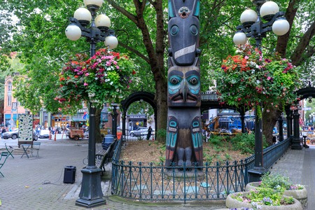Seattle, Washington - June 30, 2018 : Face of Tlingit totem pole on Pioneer Square in Seattle. Pioneer Square was city center where founders settled in 1852.のeditorial素材