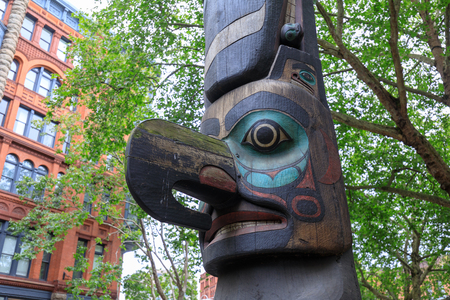 Seattle, Washington - June 30, 2018 : Face of Tlingit totem pole on Pioneer Square in Seattle. Pioneer Square was city center where founders settled in 1852.のeditorial素材