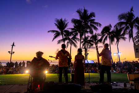 Honolulu, Hawaii - Dec 23, 2018 : Tropical colorful sunset with Orchestra and palm trees silhouette in Waikiki beachのeditorial素材