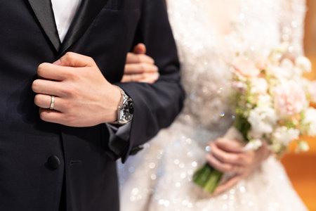 Bride and groom together, and holding the wedding bouquet in wedding dayの写真素材