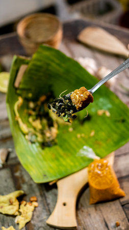 traditional food from indonesia on wooden cutting board and a garlic and chilli with wooden...